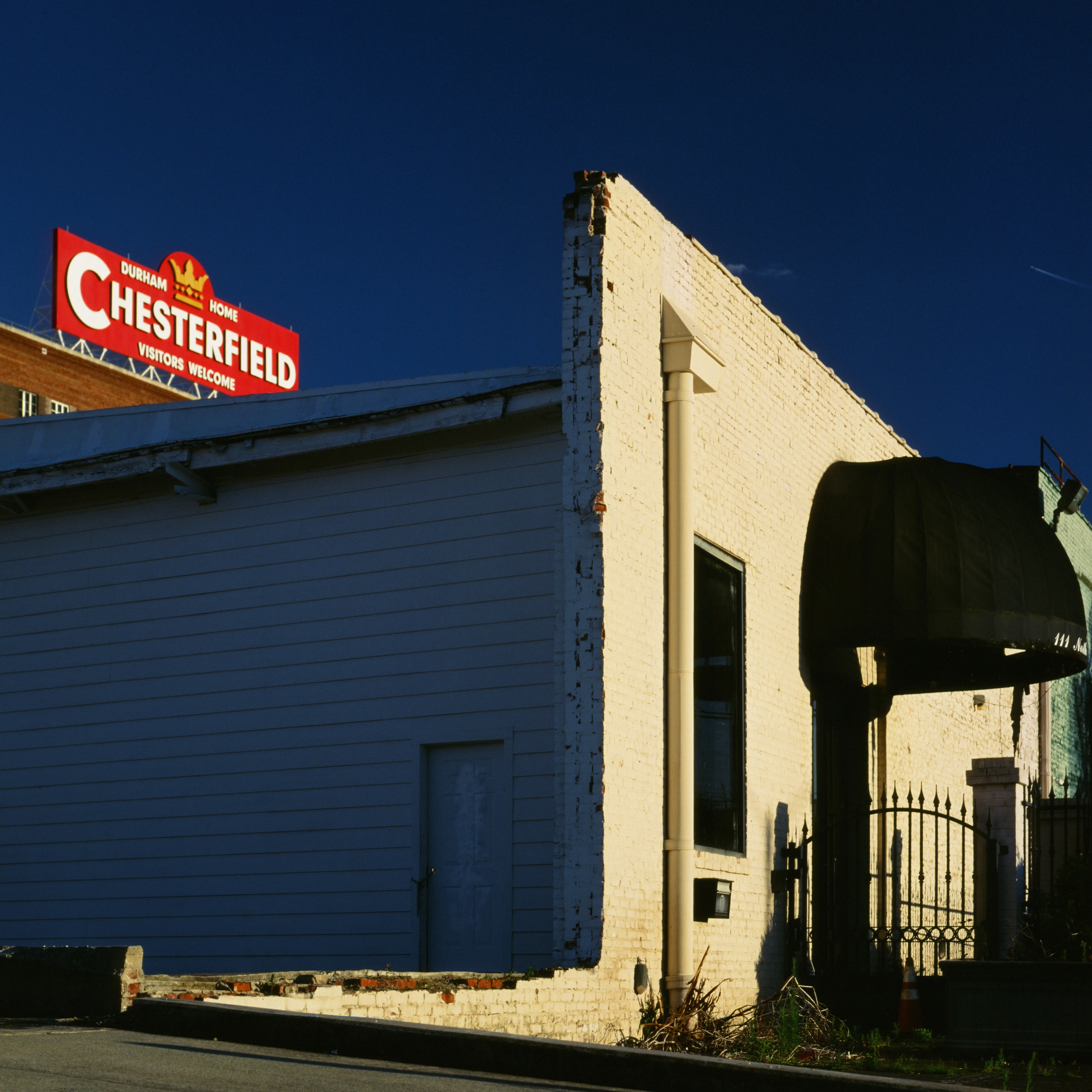 Chesterfield sign over a sunlit corner storefront, Durham NC